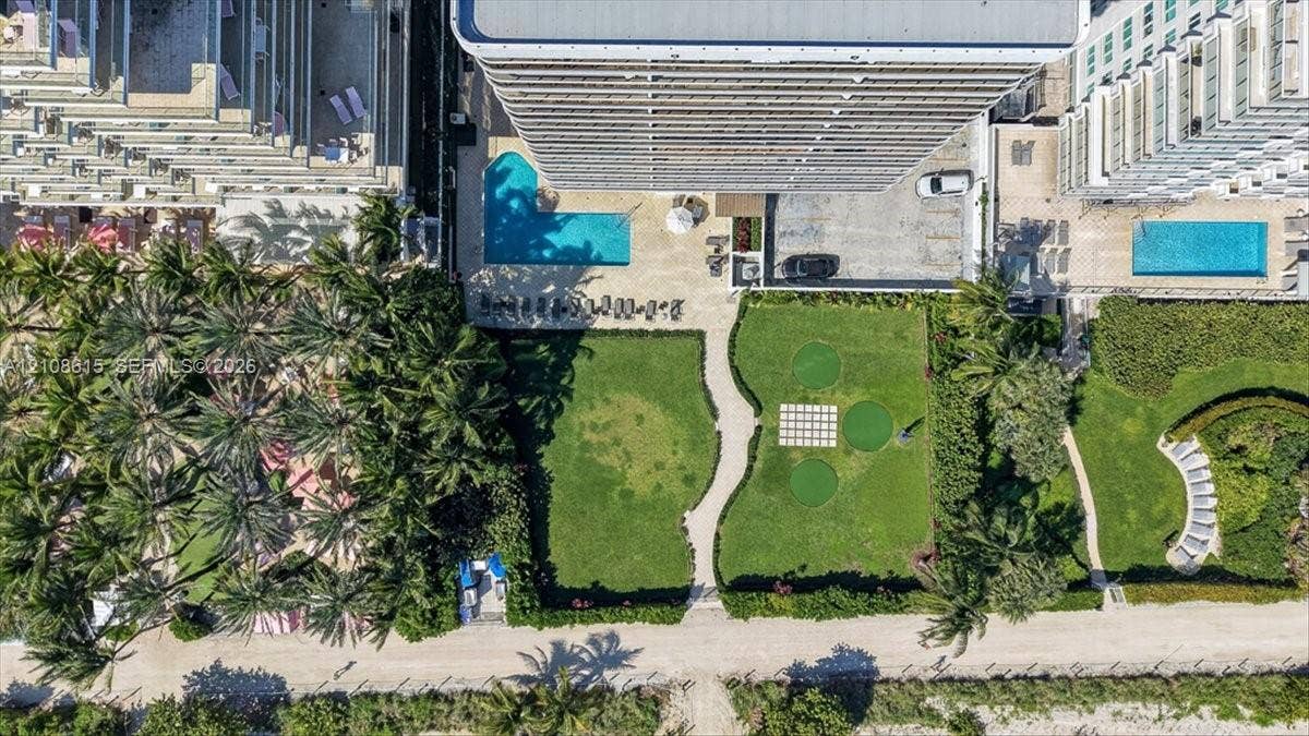 9455 Collins Avenue, #1201, Surfside, FL 33154 Aerial perspective featuring a swimming pool, manicured lawn areas, paved walkways, and integrated recreational turf spaces