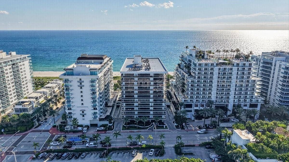 9455 Collins Avenue, #1201, Surfside, FL 33154 Coastal high-rise buildings featuring expansive glass-railed balconies and direct oceanfront positioning
