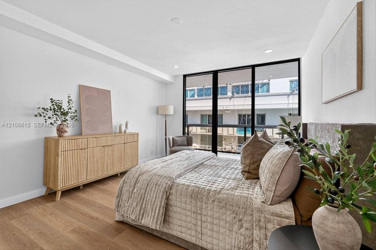 9455 Collins Avenue, #1201, Surfside, FL 33154 Floor-to-ceiling windows with black frames, wood-finish flooring, and recessed ceiling lighting