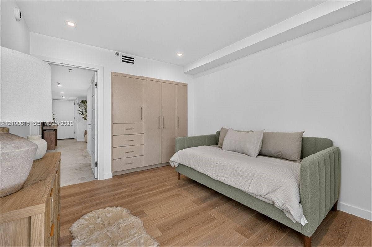 9455 Collins Avenue, #1201, Surfside, FL 33154 Neutral-toned, built-in cabinetry featuring integrated storage drawers and recessed ceiling lighting over wood-finish flooring