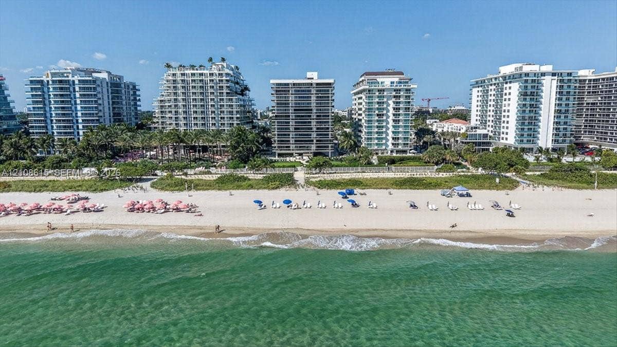 9455 Collins Avenue, #1201, Surfside, FL 33154 Aerial perspective of coastal high-rise properties featuring direct beach access, extensive sandy shoreline, and proximity to ocean waters