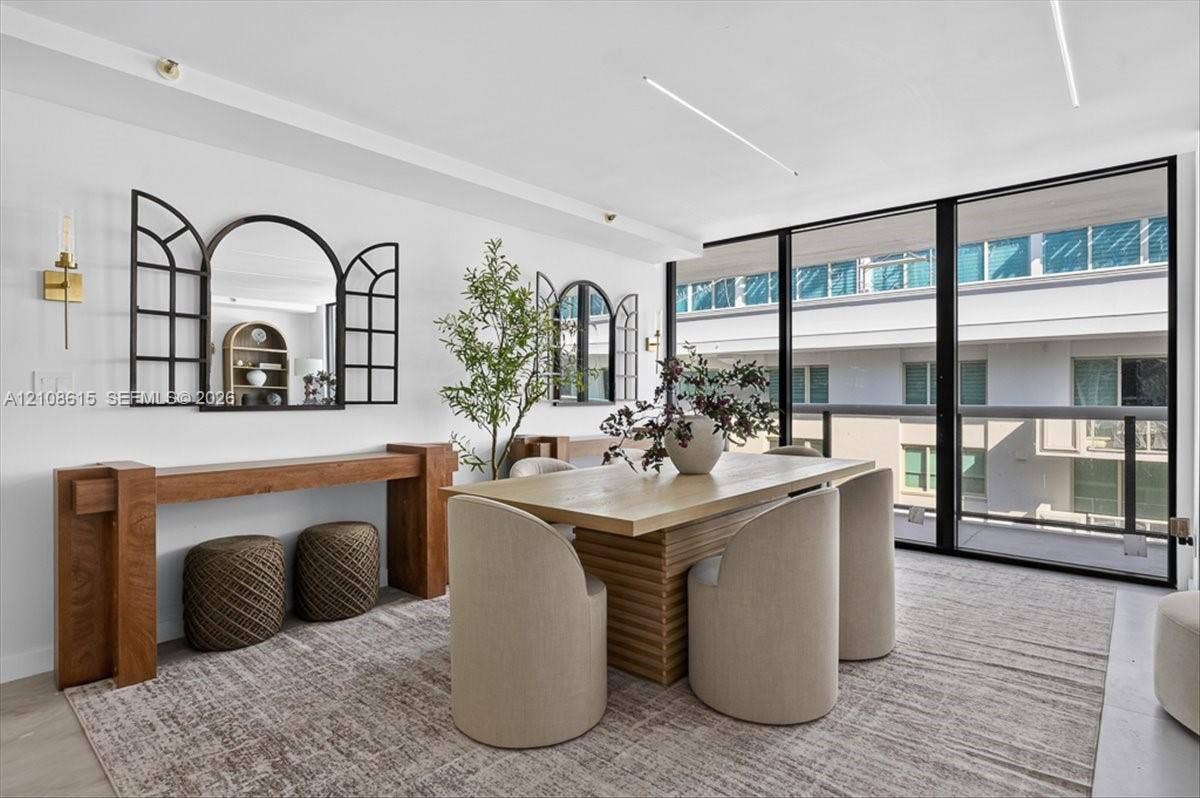 9455 Collins Avenue, #1201, Surfside, FL 33154 Floor-to-ceiling windows with black framing, wood-finish flooring, and recessed linear lighting
