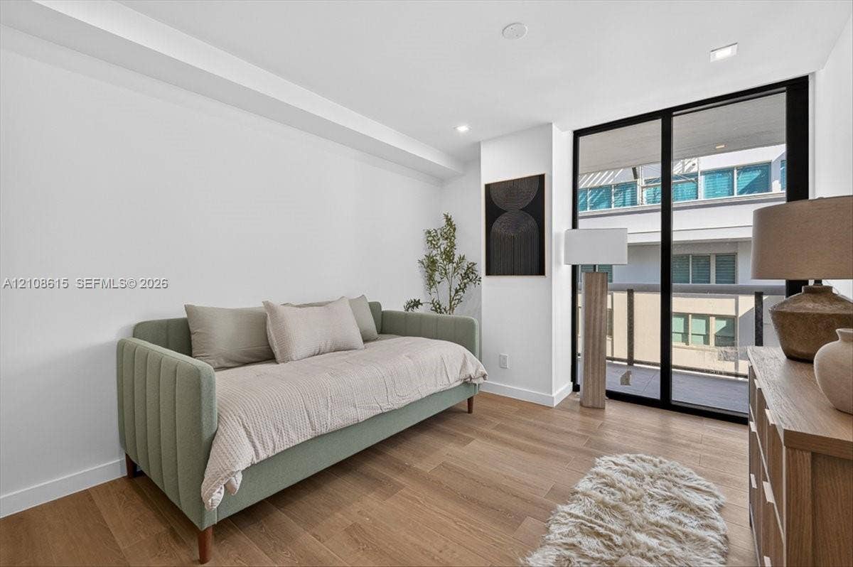 9455 Collins Avenue, #1201, Surfside, FL 33154 Room featuring wood-finish flooring, recessed lighting, and floor-to-ceiling sliding glass doors opening to an exterior balcony