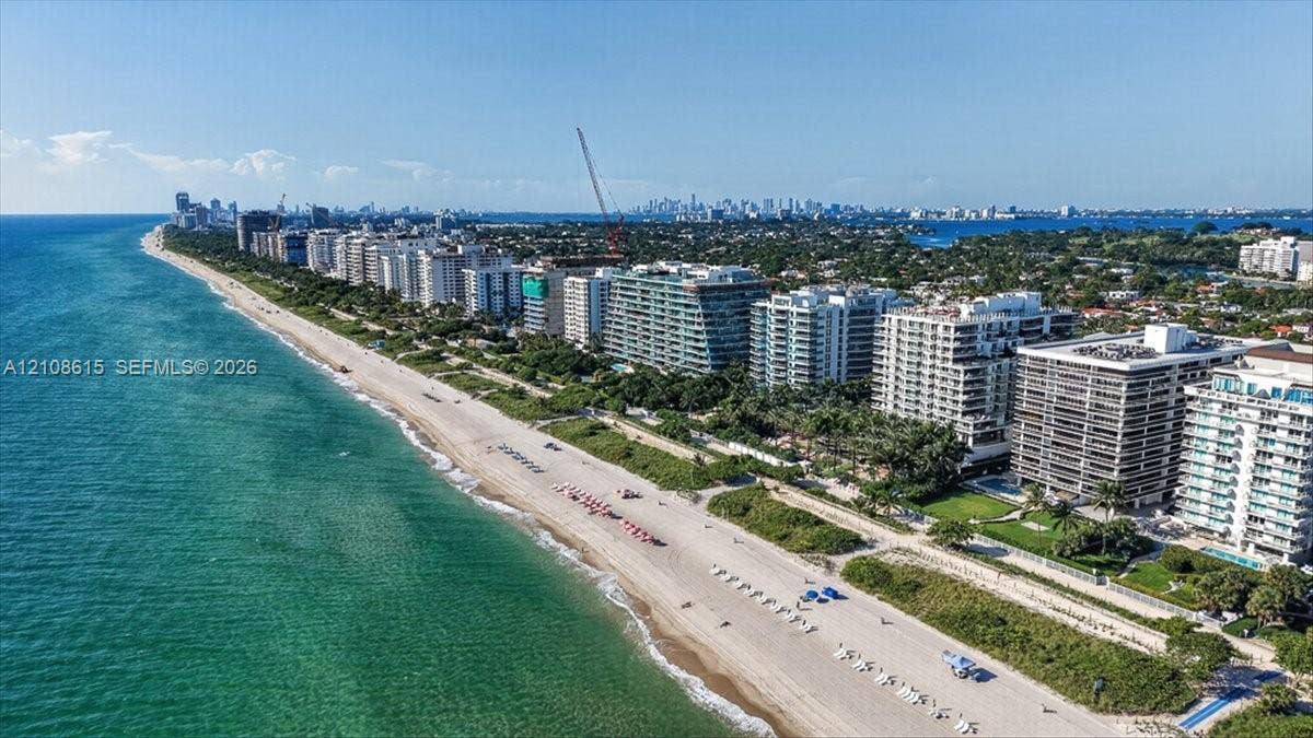 9455 Collins Avenue, #1201, Surfside, FL 33154 Coastal aerial perspective featuring direct oceanfront positioning, expansive sandy beach frontage, and mature landscaping