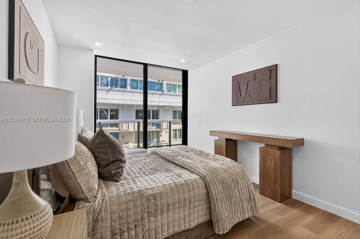 9455 Collins Avenue, #1201, Surfside, FL 33154 Floor-to-ceiling windows with black framing, wood-finish flooring, and recessed ceiling lighting
