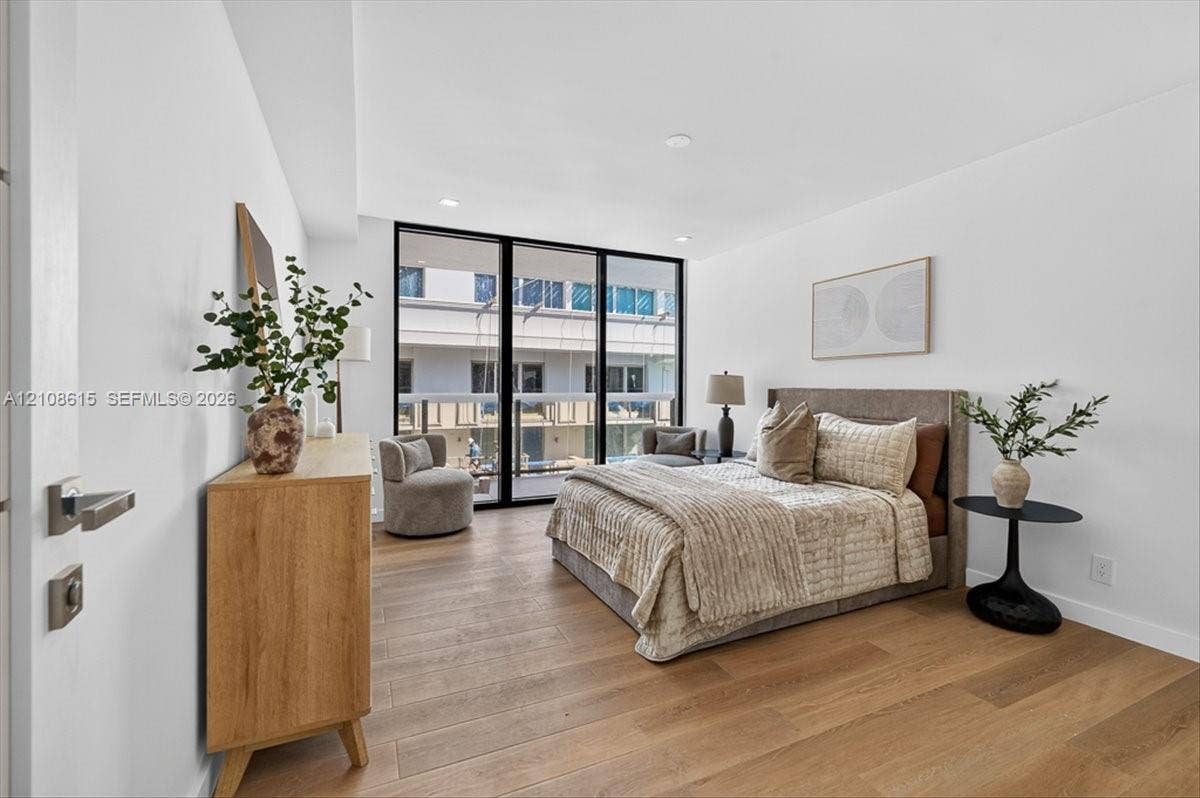 9455 Collins Avenue, #1201, Surfside, FL 33154 Wood-finish flooring, floor-to-ceiling glass panel door, recessed lighting, and modern hardware fixtures