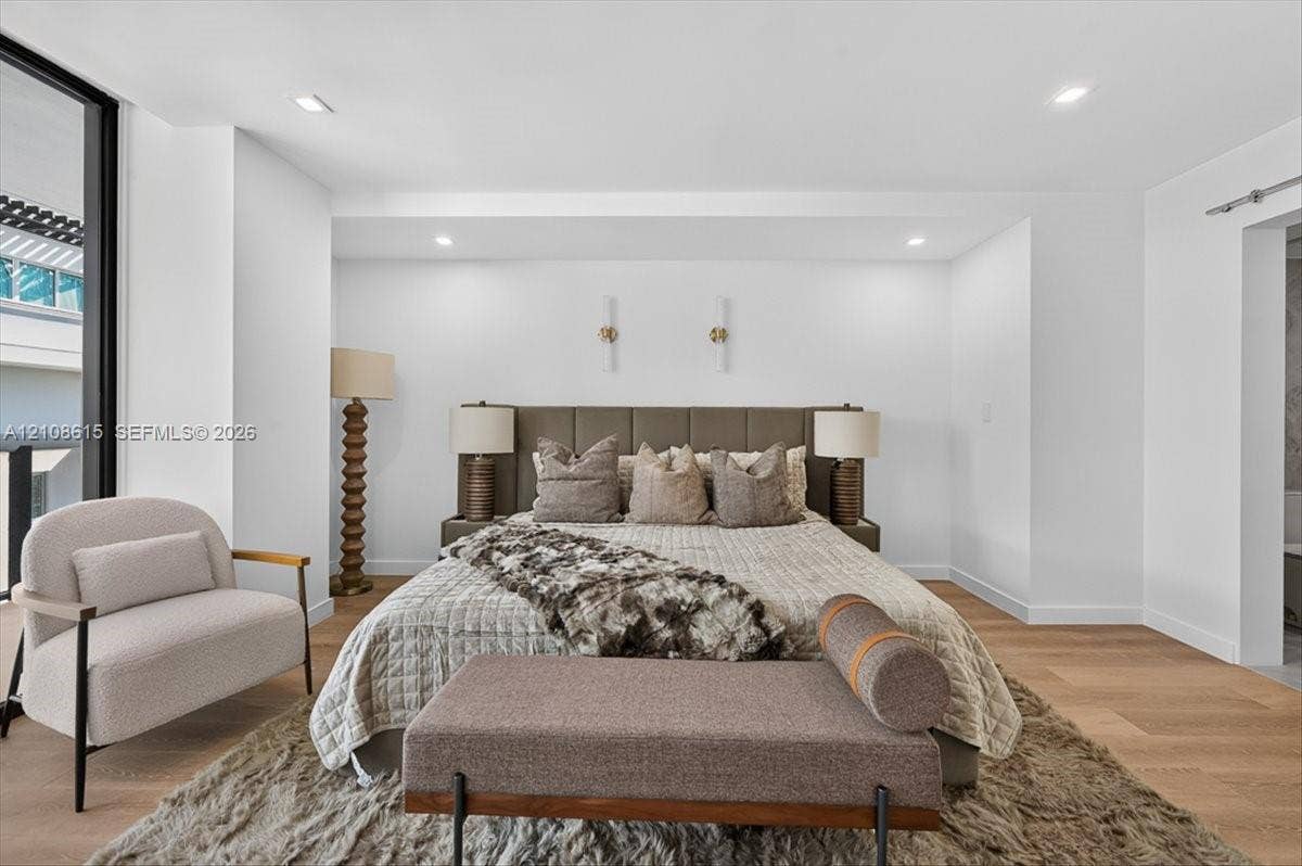 9455 Collins Avenue, #1201, Surfside, FL 33154 Wood-finish flooring, recessed lighting, and modern vertical wall-mounted fixtures