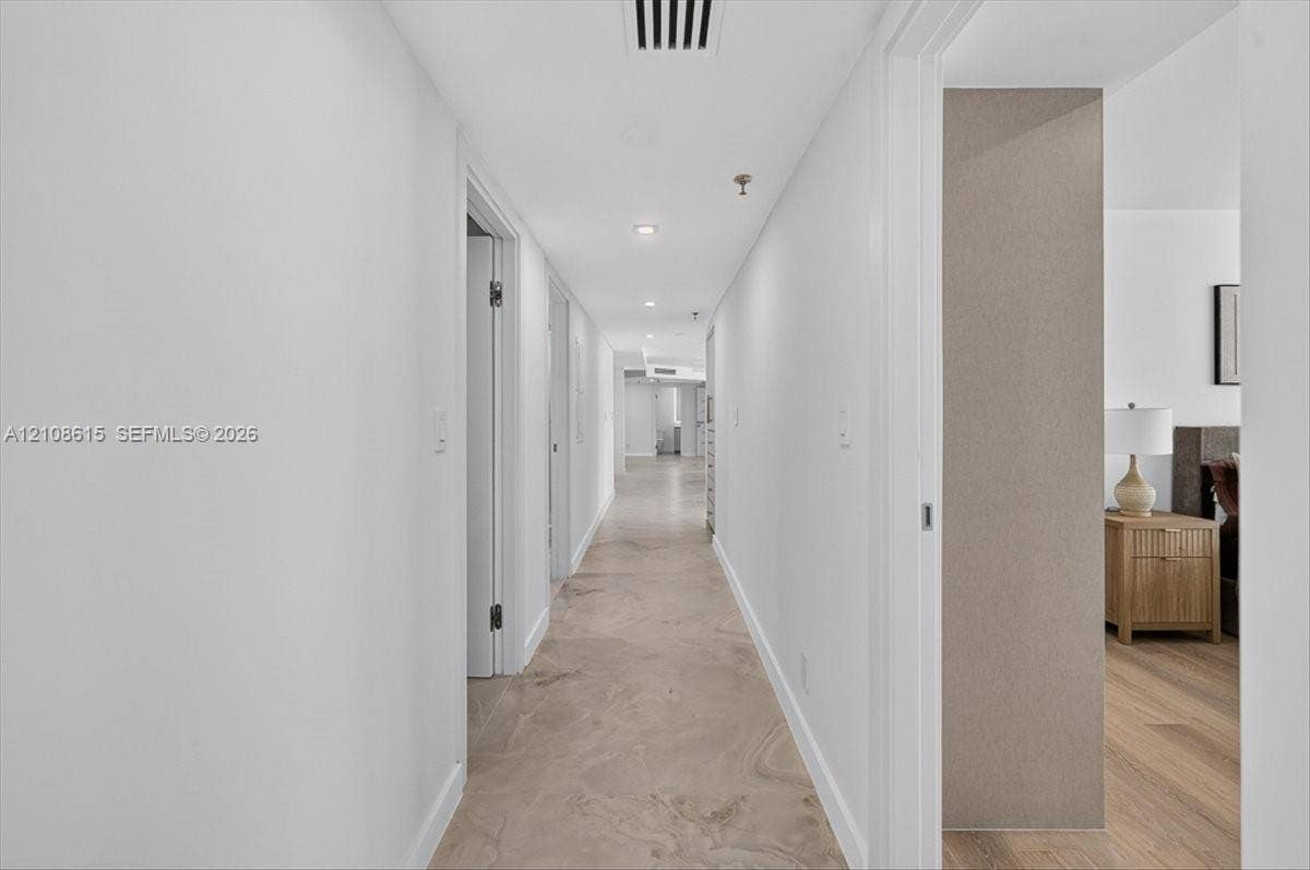 9455 Collins Avenue, #1201, Surfside, FL 33154 Hallway featuring stone-finish tile flooring, recessed ceiling lighting, and neutral wall tones