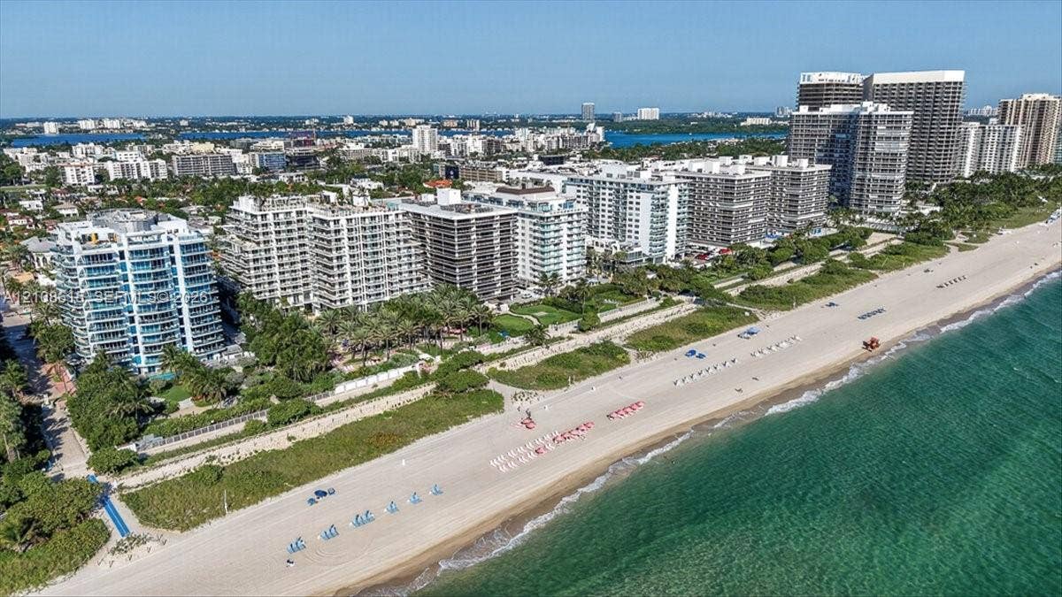 9455 Collins Avenue, #1201, Surfside, FL 33154 Aerial perspective of waterfront high-rise development featuring direct beach access, coastal shoreline, and proximity to regional urban infrastructure