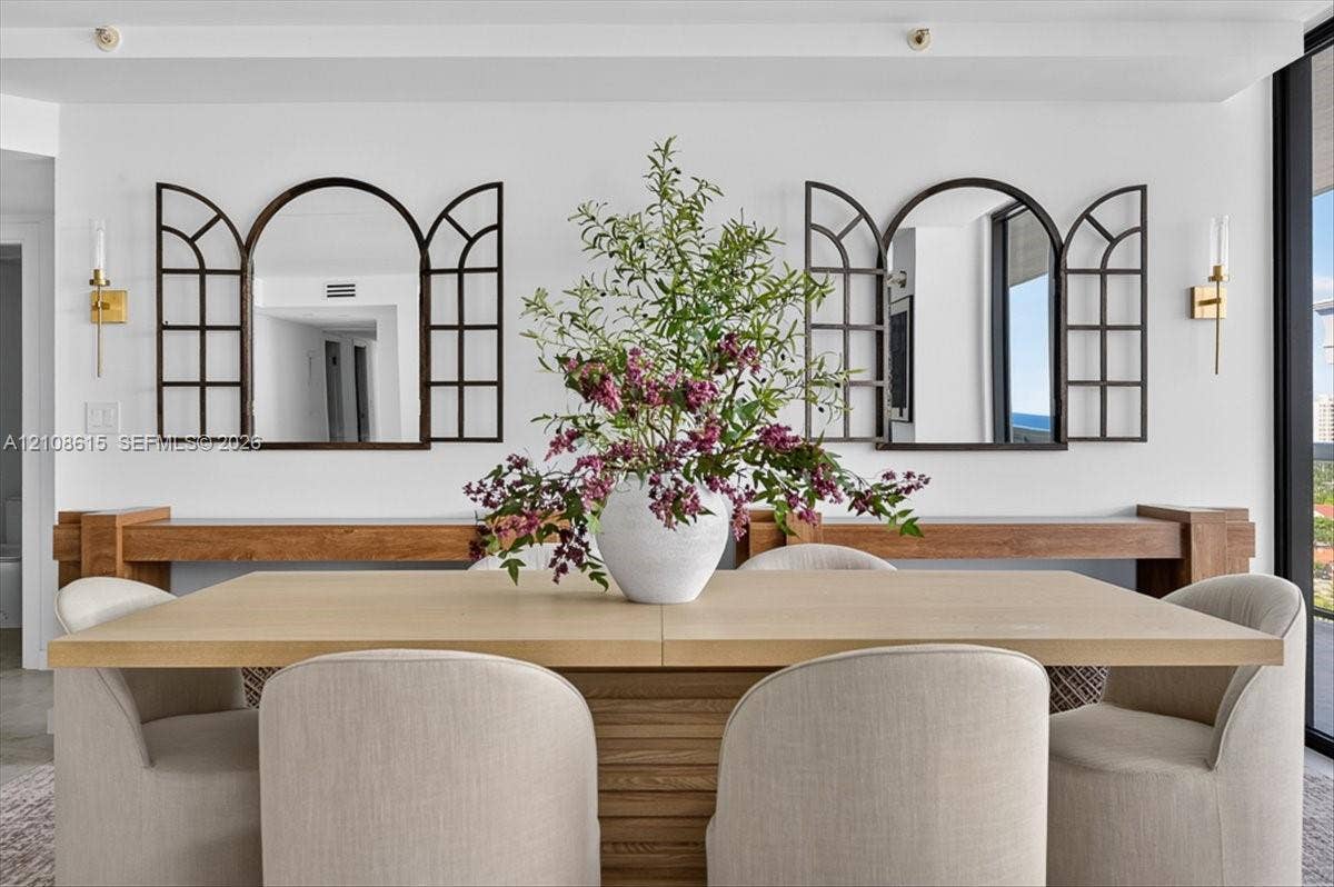 9455 Collins Avenue, #1201, Surfside, FL 33154 Custom wood wall-mounted consoles with two arched window-pane style decorative mirrors and dual metallic wall-mounted light fixtures