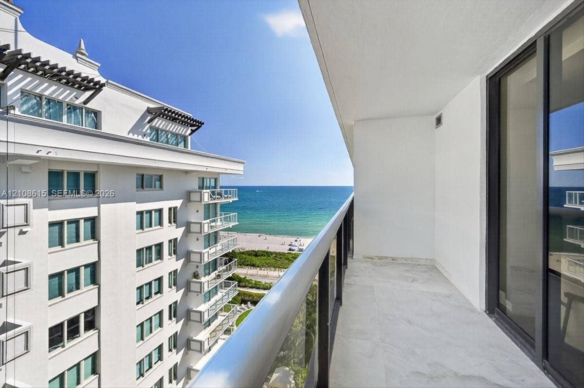 9455 Collins Avenue, #1201, Surfside, FL 33154 Private covered balcony featuring stone flooring and a glass panel railing, oriented toward the ocean
