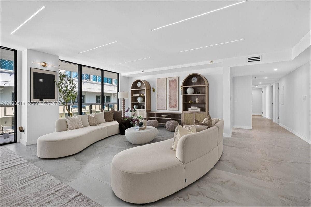 9455 Collins Avenue, #1201, Surfside, FL 33154 Open-concept interior featuring large-format tile flooring, floor-to-ceiling windows, and recessed linear LED lighting