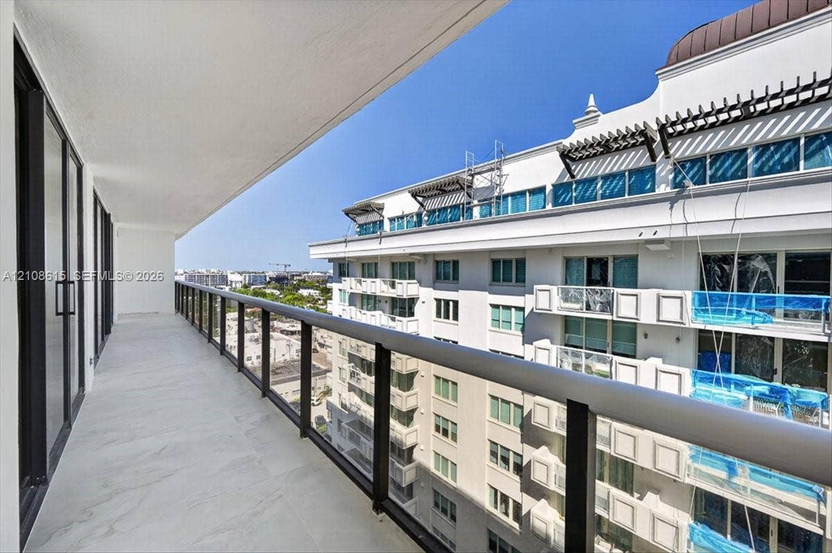 9455 Collins Avenue, #1201, Surfside, FL 33154 Covered balcony featuring tile flooring, glass panel railings, and dark metal framing