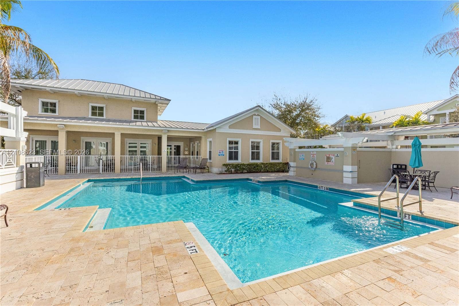 Swimming pool with stone-tiled decking and built-in entry steps