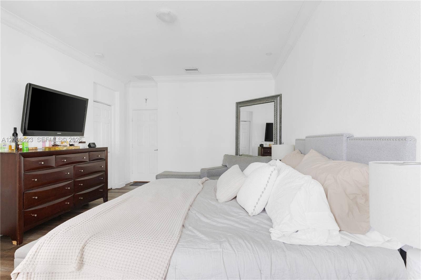 Spacious interior featuring crown molding, recessed lighting, and wood-finish flooring