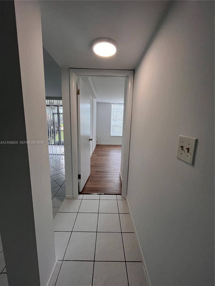3650 Inverrary Drive, #1Q, Lauderhill, FL 33319 Ceramic tile flooring, flush-mount ceiling lighting, and wood-finish flooring