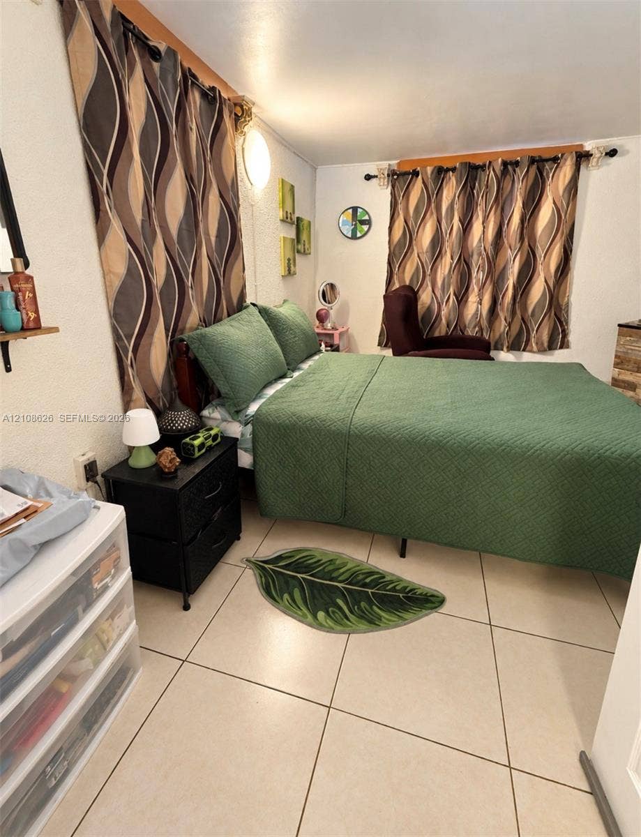971 NE 156th Terrace, North Miami Beach, FL 33162 Neutral-toned tile flooring throughout with wall-mounted lighting fixture