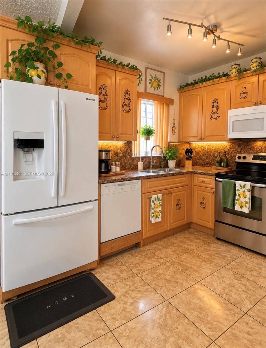 971 NE 156th Terrace, North Miami Beach, FL 33162 Kitchen featuring wood cabinetry, stone-finish countertops, stainless steel range, white French-door refrigerator, and under-cabinet lighting