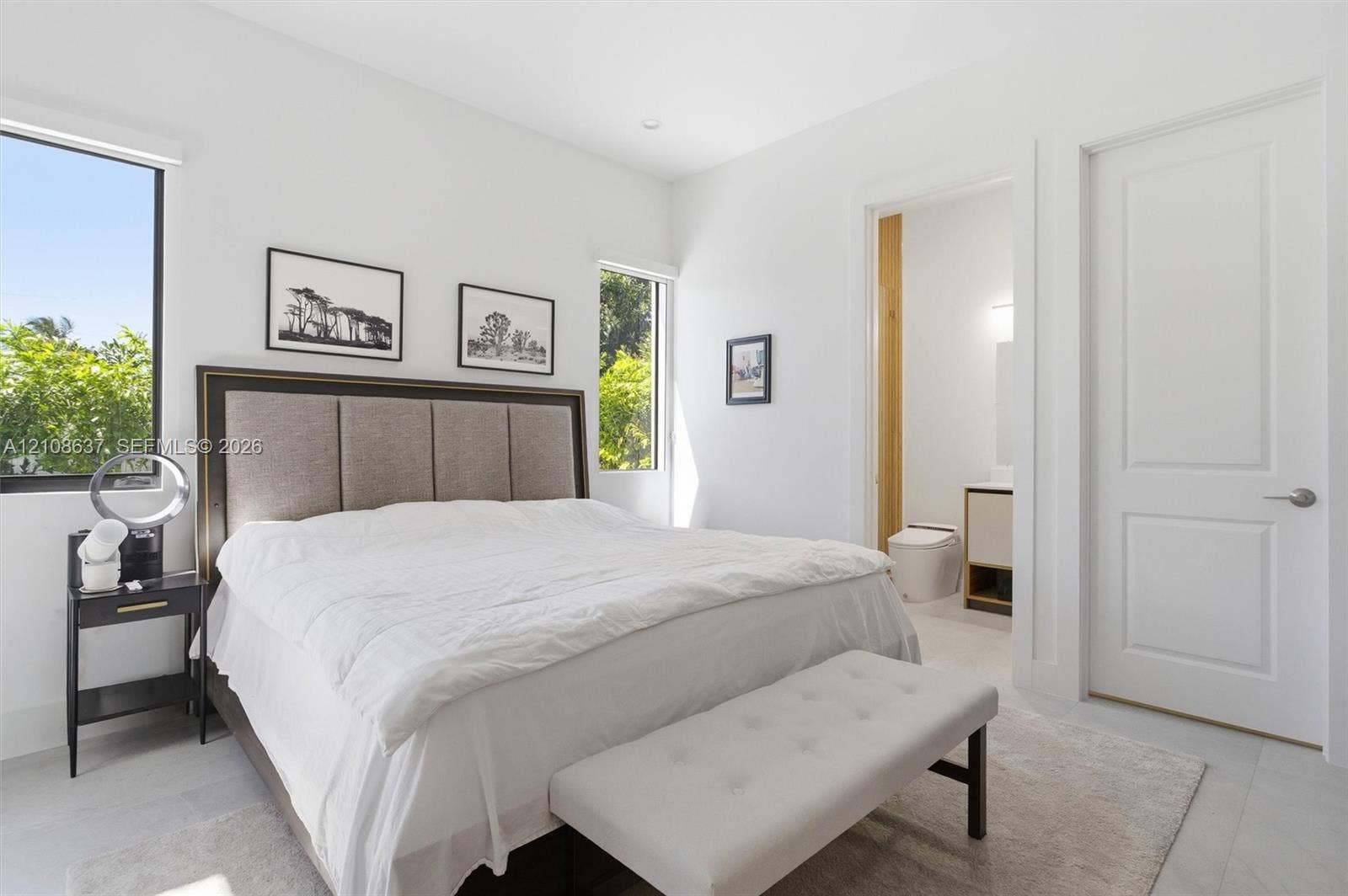 22900 SW 122nd Place, Miami, FL 33170 Light-filled space featuring large windows, neutral stone-finish flooring, recessed lighting, and a solid-core interior door
