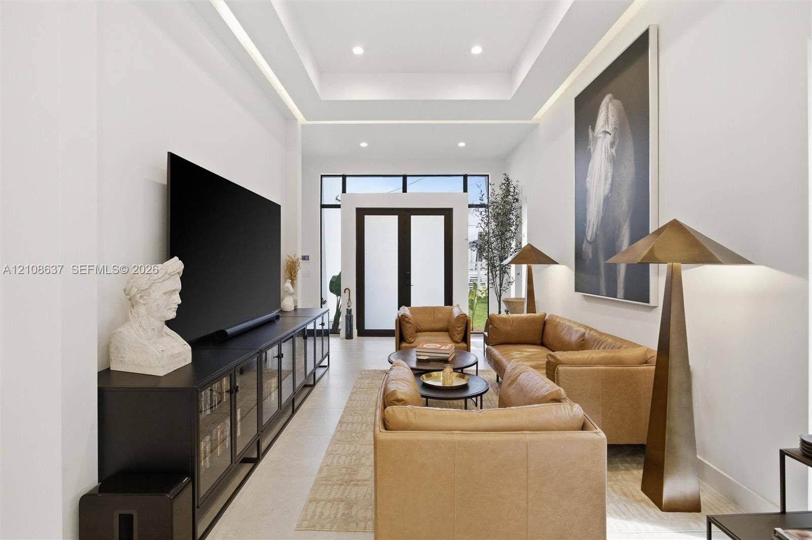 22900 SW 122nd Place, Miami, FL 33170 Tray ceiling featuring integrated recessed lighting, smooth finish walls, and glass-paneled double entry doors with dark metal framing