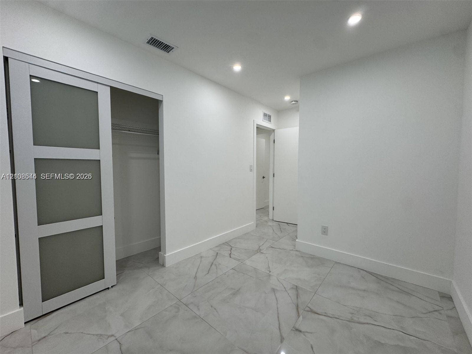 1431 N 14th Way, #rear, Hollywood, Hollywood, FL 33020 Large-format stone-style tile flooring, sliding barn door with frosted glass panels, and recessed ceiling lighting
