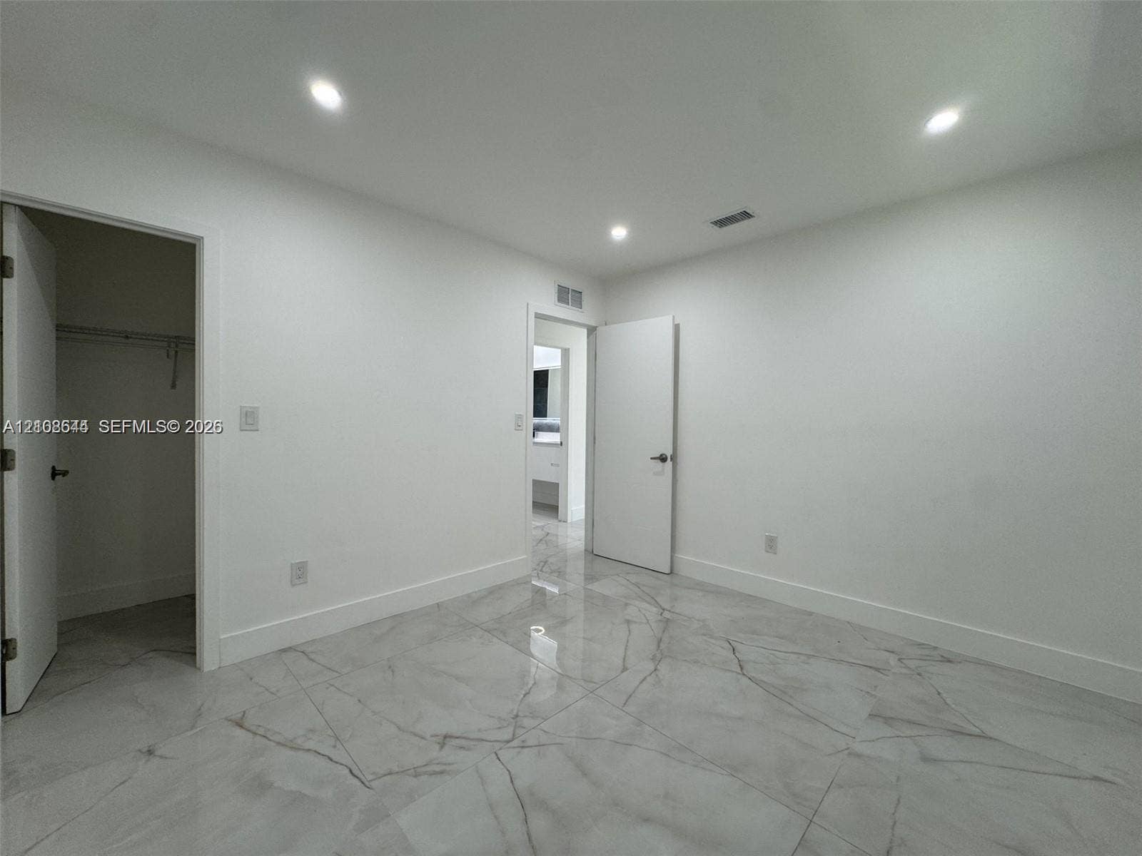 1431 N 14th Way, #rear, Hollywood, Hollywood, FL 33020 Large-format polished tile flooring with veining detail, recessed ceiling lighting, and built-in closet storage