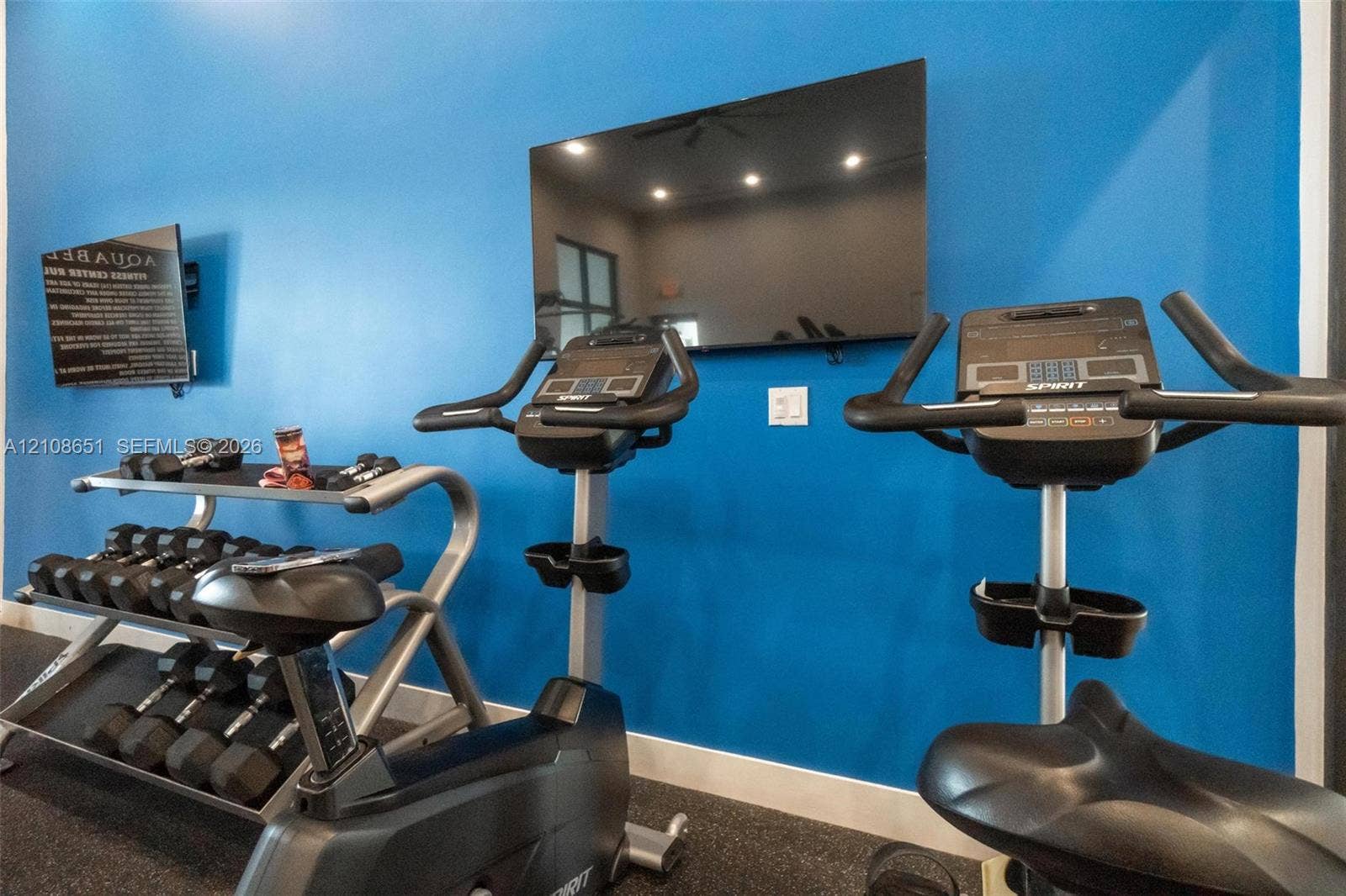 3288 W 106th Terrace, #3288, Hialeah, Hialeah, FL 33018 Fitness center featuring wall-mounted television, rubberized flooring, and recessed ceiling lighting