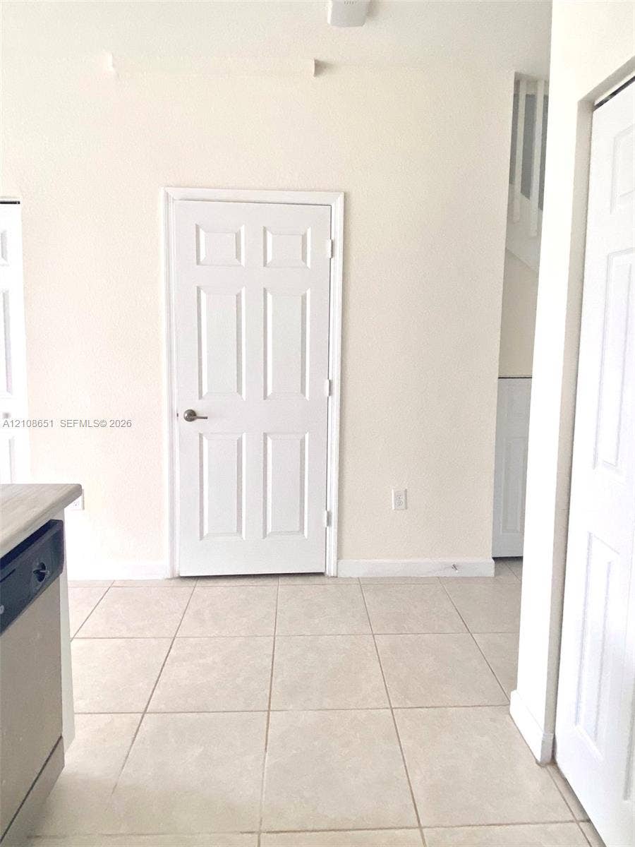 3288 W 106th Terrace, #3288, Hialeah, Hialeah, FL 33018 Neutral-toned tile flooring, six-panel interior doors, and clean-finished walls