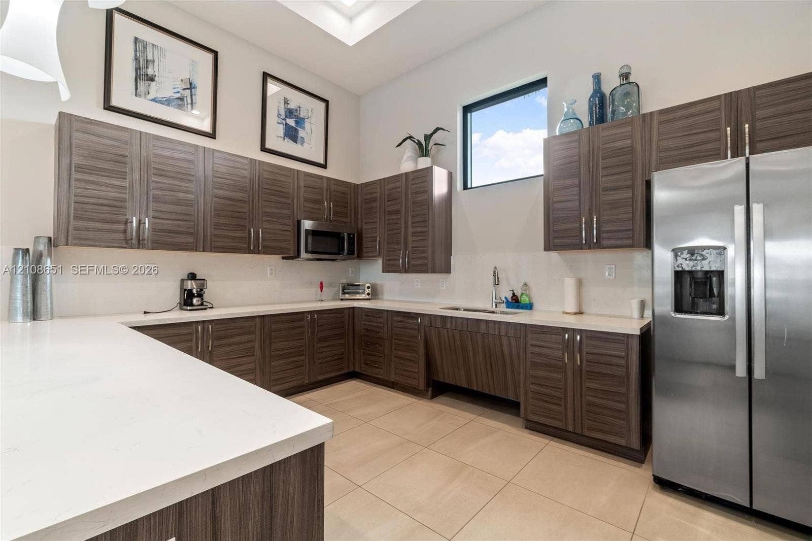 3288 W 106th Terrace, #3288, Hialeah, Hialeah, FL 33018 Kitchen featuring horizontal-grain wood cabinetry, white stone countertops, stainless steel appliances, tile flooring, and high ceilings with recessed lighting
