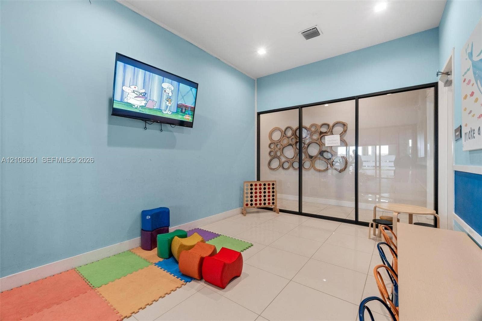 3288 W 106th Terrace, #3288, Hialeah, Hialeah, FL 33018 Neutral-toned tile flooring, recessed ceiling lighting, and a floor-to-ceiling glass wall partition with a black metal frame