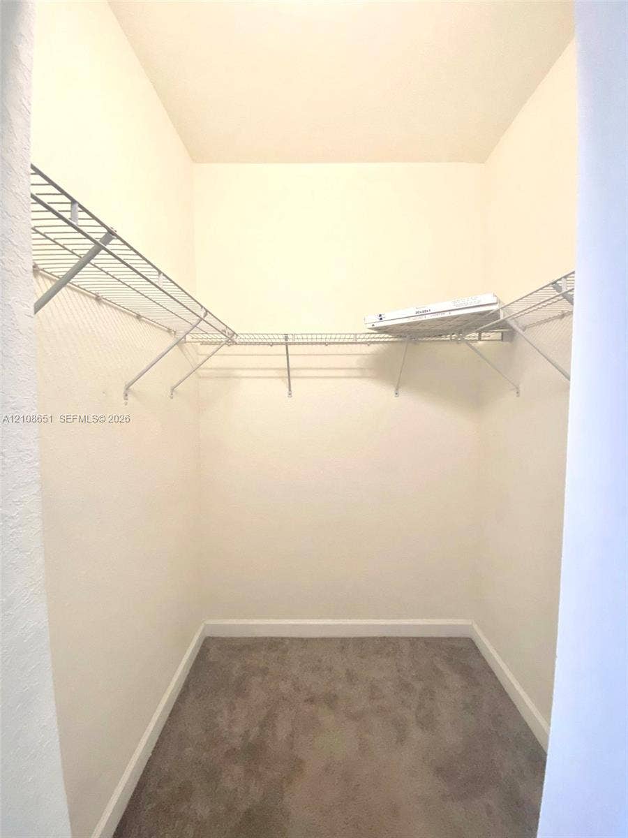 3288 W 106th Terrace, #3288, Hialeah, Hialeah, FL 33018 Walk-in storage space featuring neutral carpeting and wrap-around wire shelving