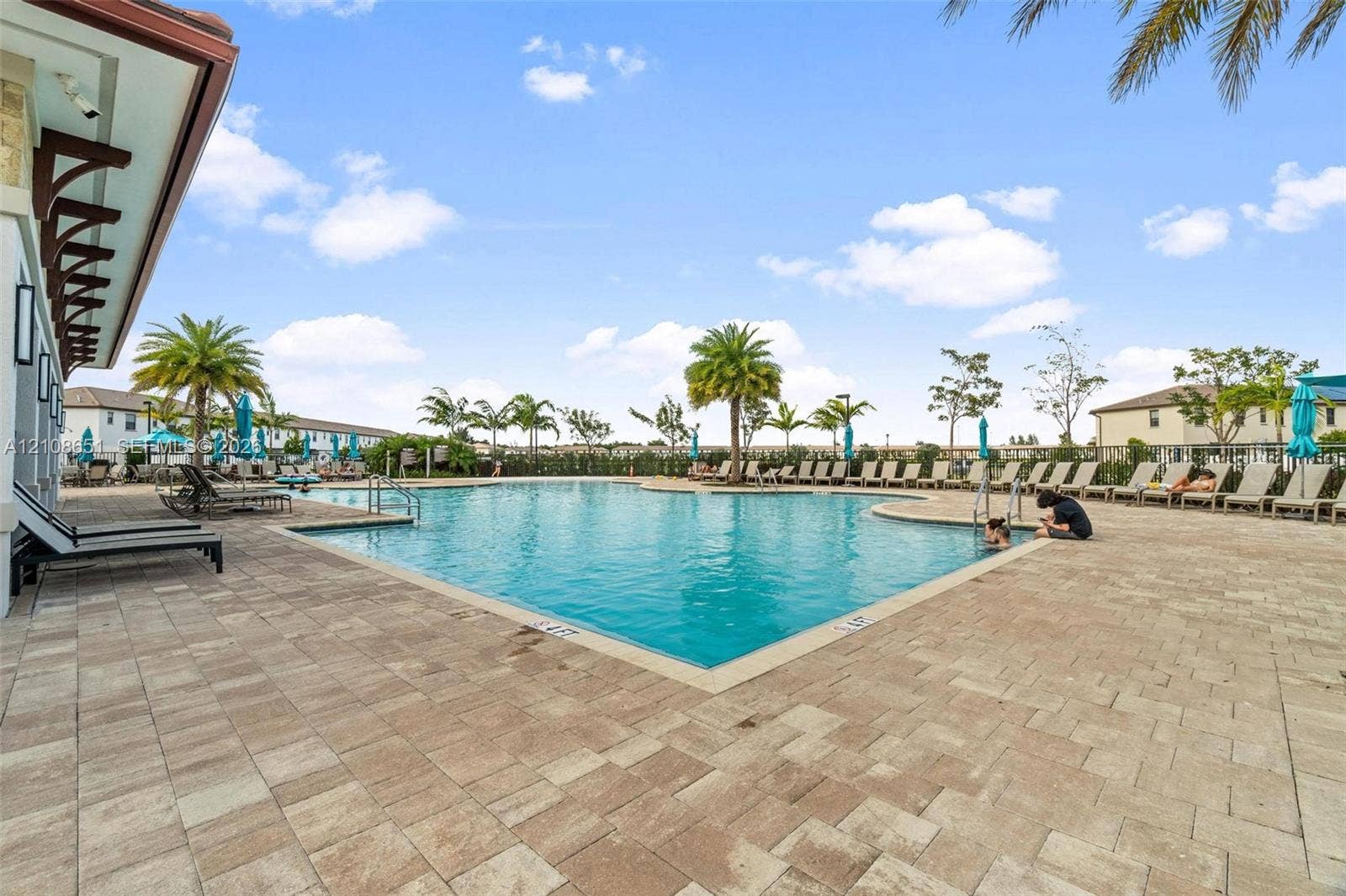 3288 W 106th Terrace, #3288, Hialeah, Hialeah, FL 33018 In-ground swimming pool with a stone paver deck and perimeter landscaping