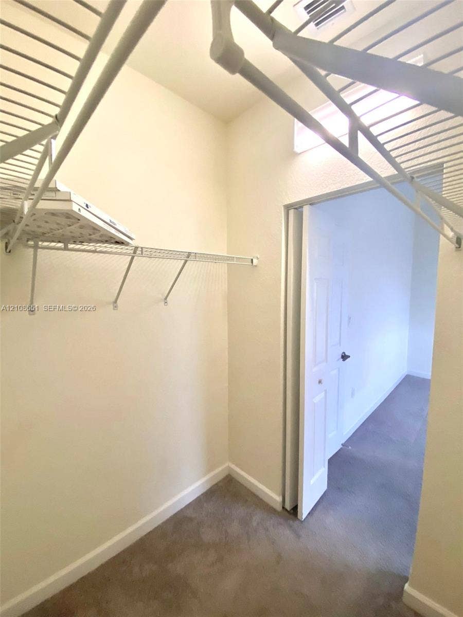 3288 W 106th Terrace, #3288, Hialeah, Hialeah, FL 33018 Storage area featuring wire shelving and carpeted flooring