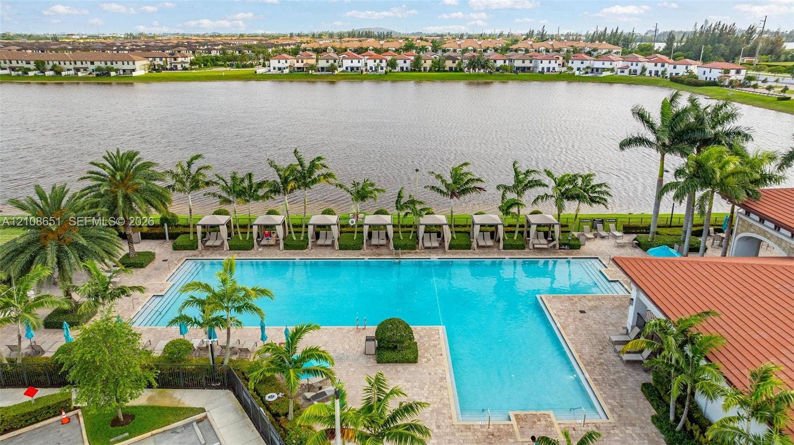 3288 W 106th Terrace, #3288, Hialeah, Hialeah, FL 33018 Large swimming pool with paver decking, cabanas, and integrated landscaping overlooking a lake