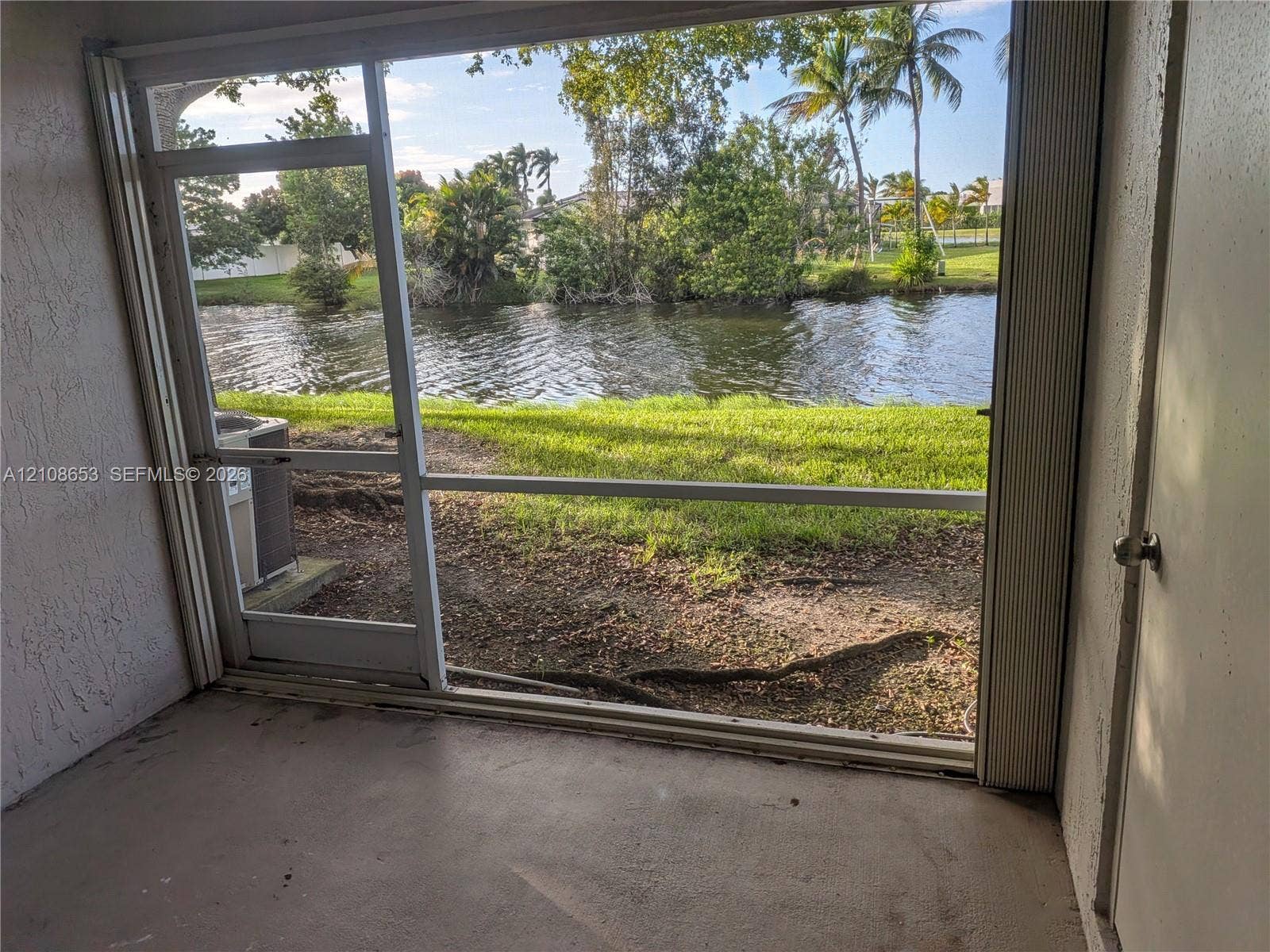291 Duval Court, #0, Weston, Weston, FL 33326 Enclosed porch featuring a screen frame, concrete flooring, and water frontage