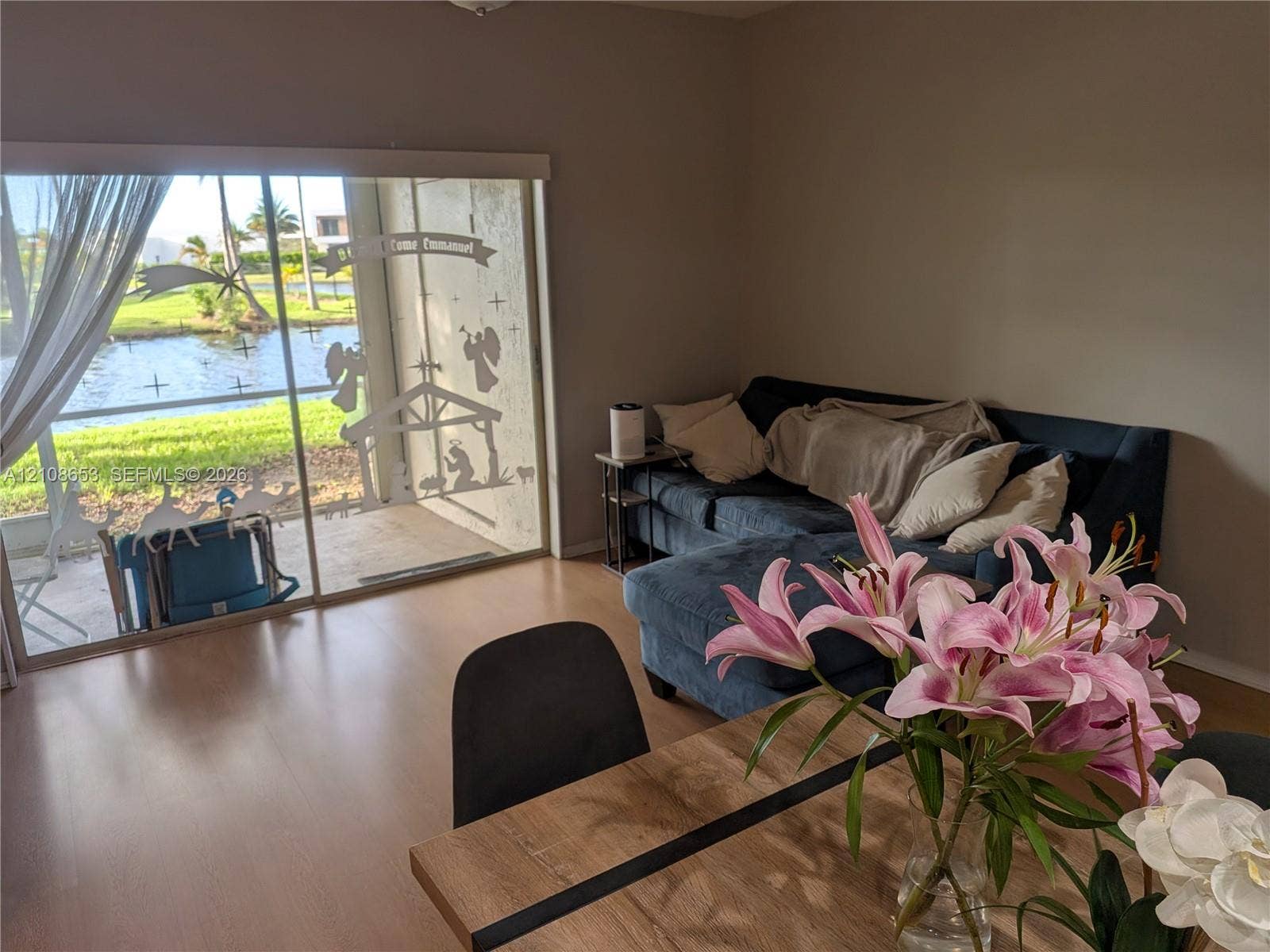 291 Duval Court, #0, Weston, Weston, FL 33326 Large sliding glass doors opening to a concrete patio with water frontage and wood-finish flooring