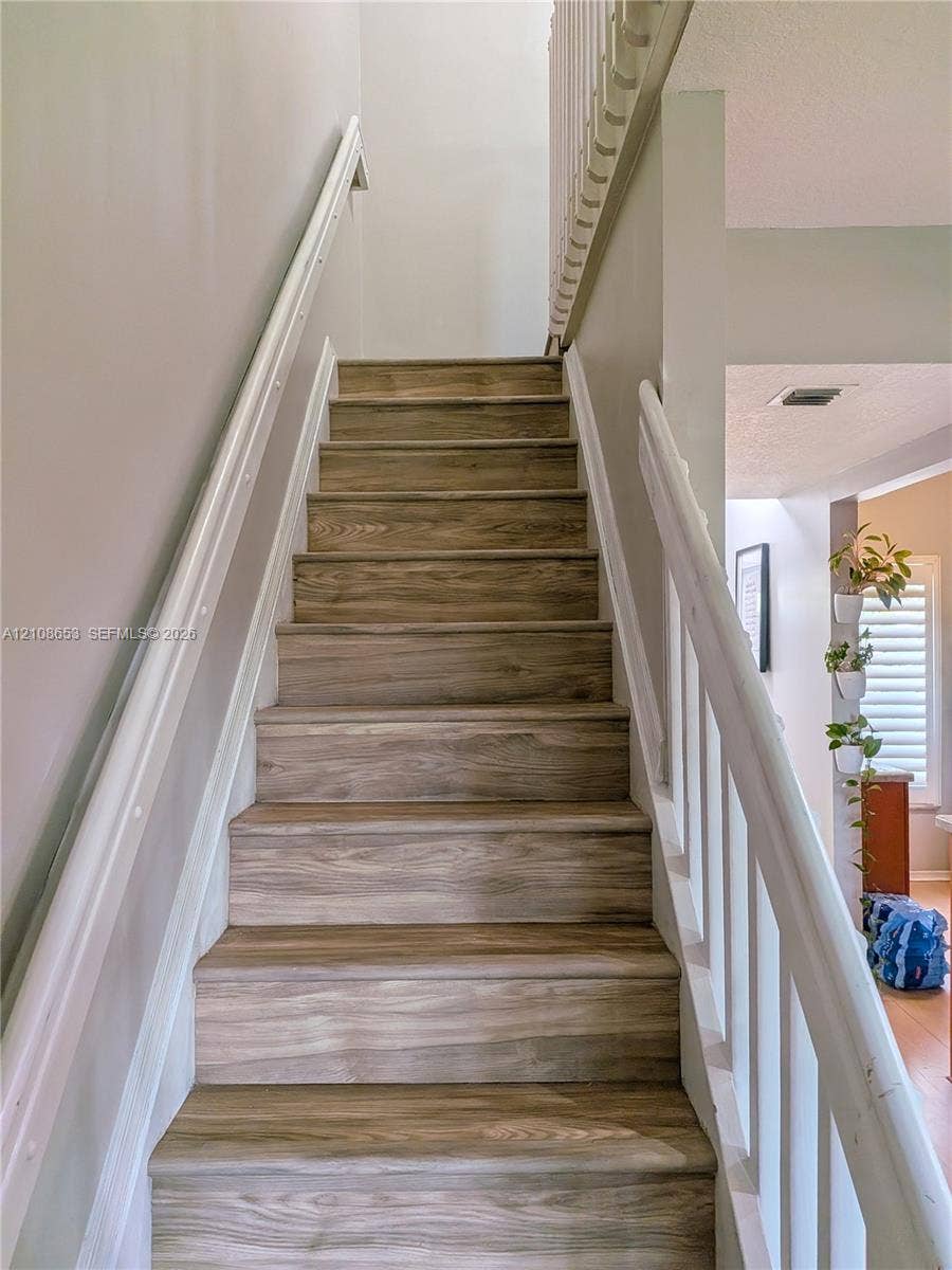 291 Duval Court, #0, Weston, Weston, FL 33326 Staircase featuring wood-finish treads and white painted handrails with balusters