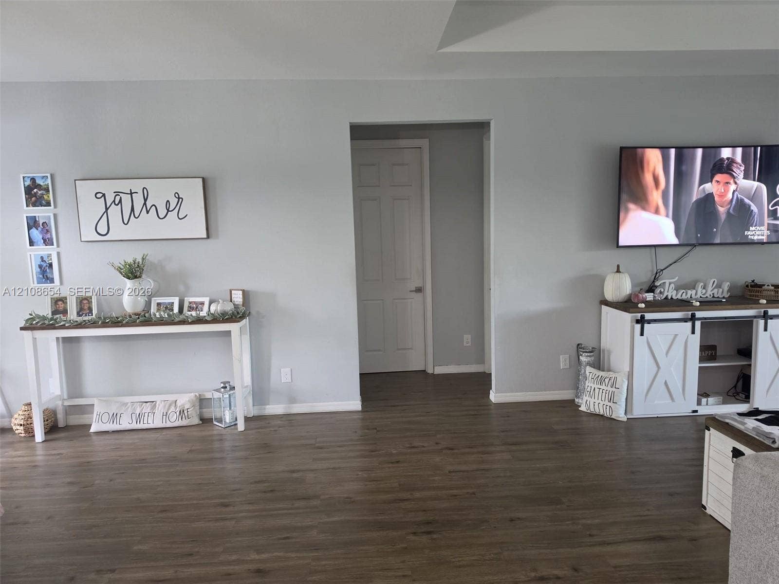 1225 SW 35 Terrace, Cape Coral, FL 33914 Neutral-toned walls paired with wood-finish flooring and a central six-panel interior door