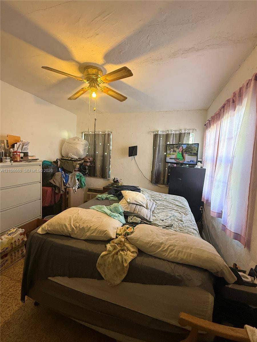262 NE 111th Street, Miami, FL 33161 Room featuring a ceiling fan, multiple windows, and smooth-surface flooring