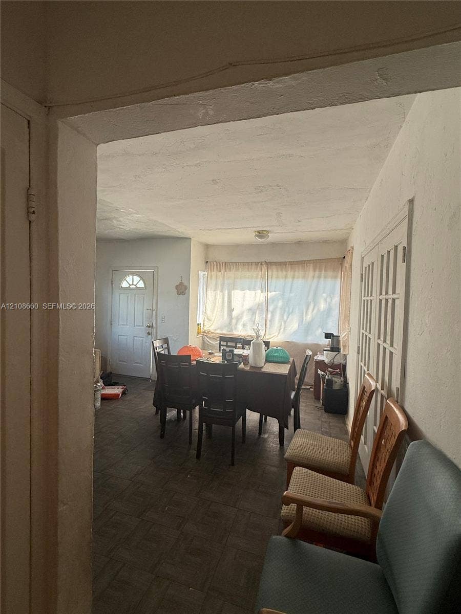 262 NE 111th Street, Miami, FL 33161 Tiled flooring, interior French doors with glass panes, and an exterior door with a decorative window insert