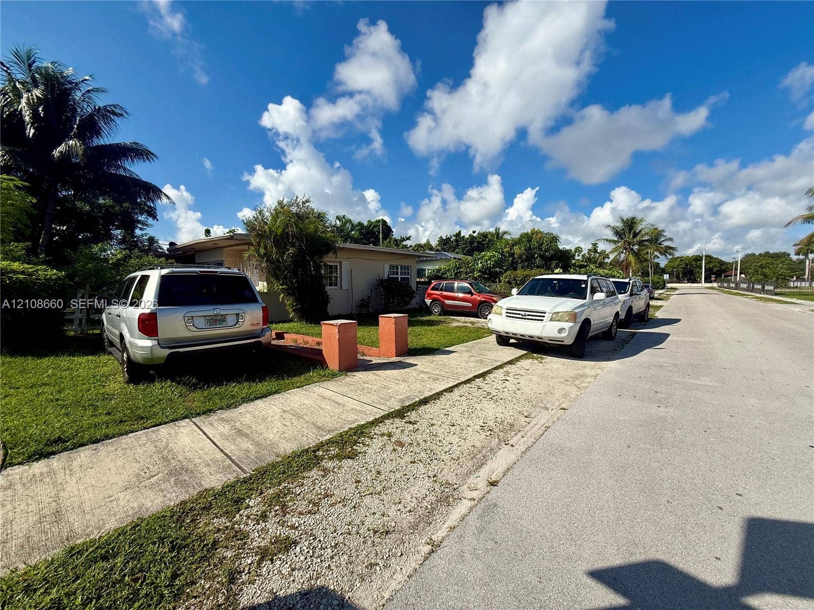 262 NE 111th Street, Miami, FL 33161 Single-story exterior with a low-pitched roof, concrete driveway, and established landscaping