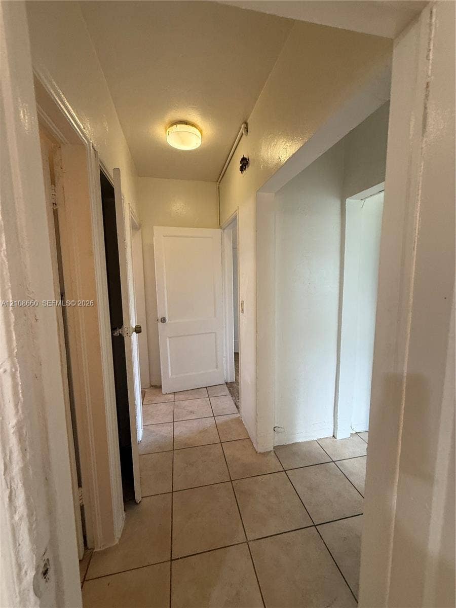262 NE 111th Street, Miami, FL 33161 Ceramic tile flooring, multiple interior solid-core doors, and flush-mount ceiling lighting