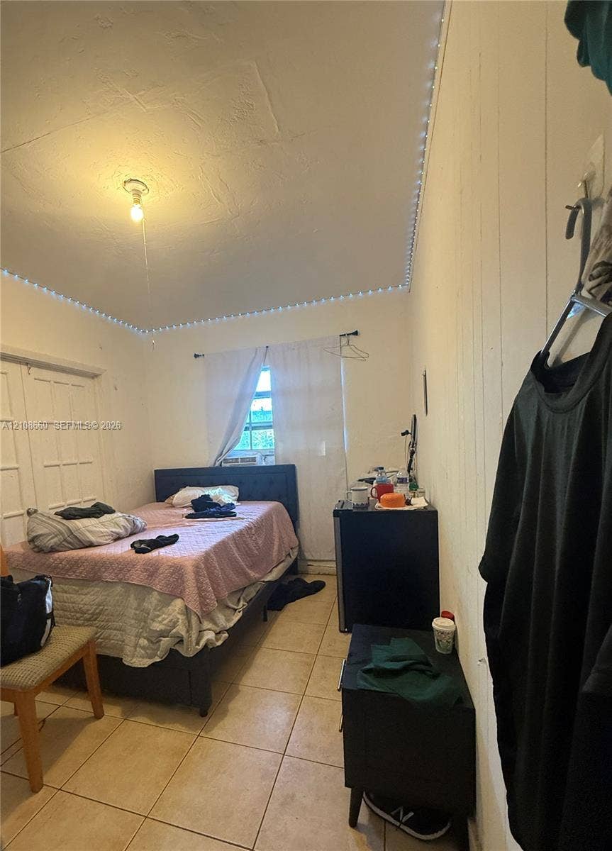 262 NE 111th Street, Miami, FL 33161 Ceramic tile flooring, paneled wall detailing, and double-door closet