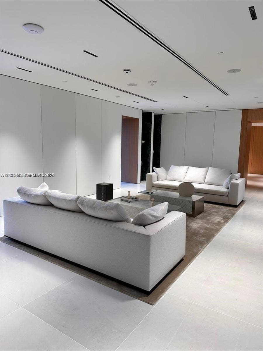 300 Biscayne Boulevard, #2709W, Miami, Miami, FL 33131 Large-format stone flooring, recessed linear lighting, minimalist flush-panel wall treatments, and integrated ceiling speakers