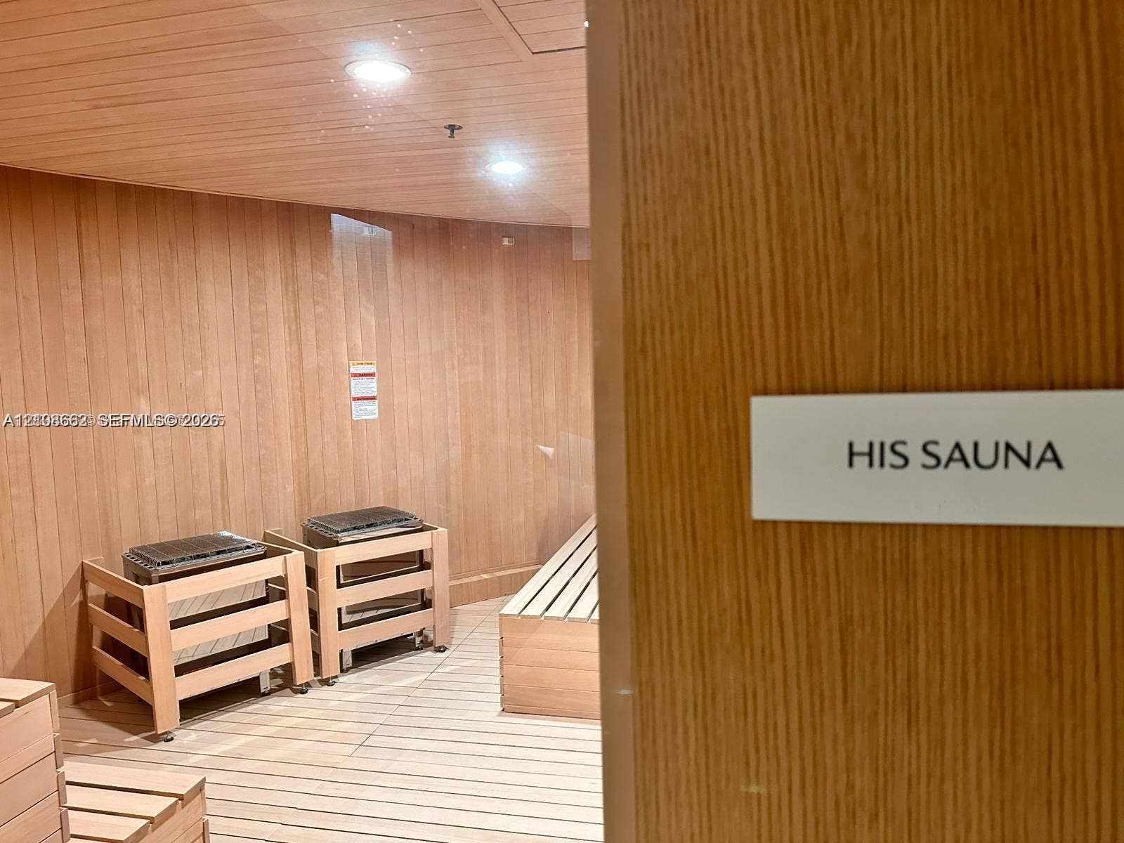 300 Biscayne Boulevard, #2709W, Miami, Miami, FL 33131 Sauna featuring natural wood-paneled walls and ceiling, tiered wood benches, and two integrated heating units with recessed lighting