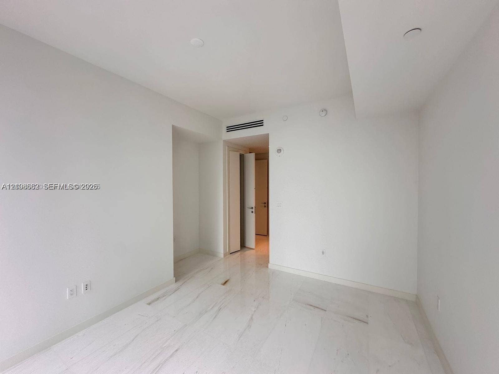 300 Biscayne Boulevard, #2709W, Miami, Miami, FL 33131 Interior space featuring polished stone-finish flooring, neutral wall finishes, recessed ceiling lighting, and a doorway with a swinging door