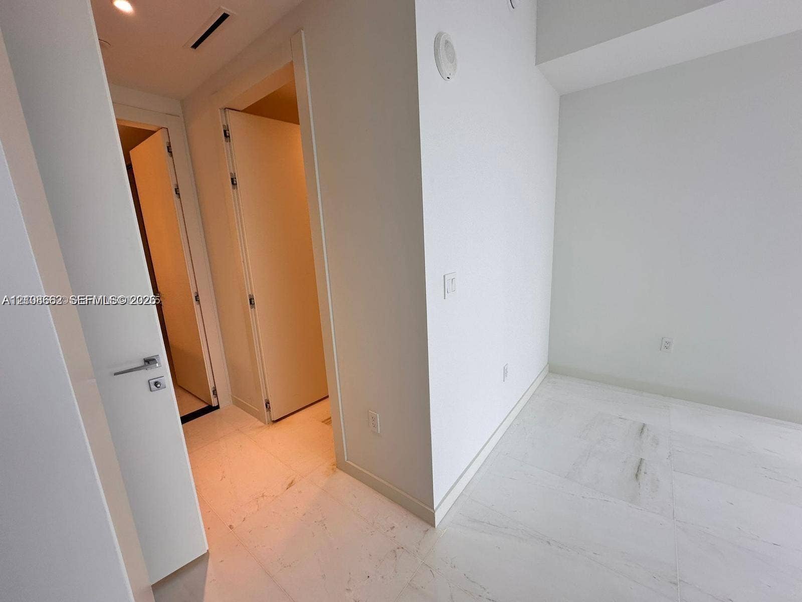 300 Biscayne Boulevard, #2709W, Miami, Miami, FL 33131 Interior space featuring white stone-finish flooring, recessed lighting, and solid-core doors with contemporary brushed-metal hardware