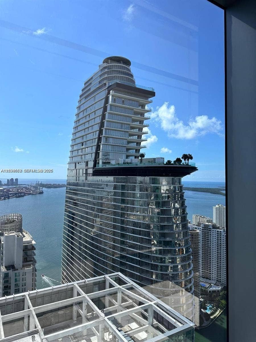 300 Biscayne Boulevard, #2709W, Miami, Miami, FL 33131 High-rise architectural structure featuring a prominent cantilevered sky deck, expansive glass curtain walls, and a multi-level terrace design