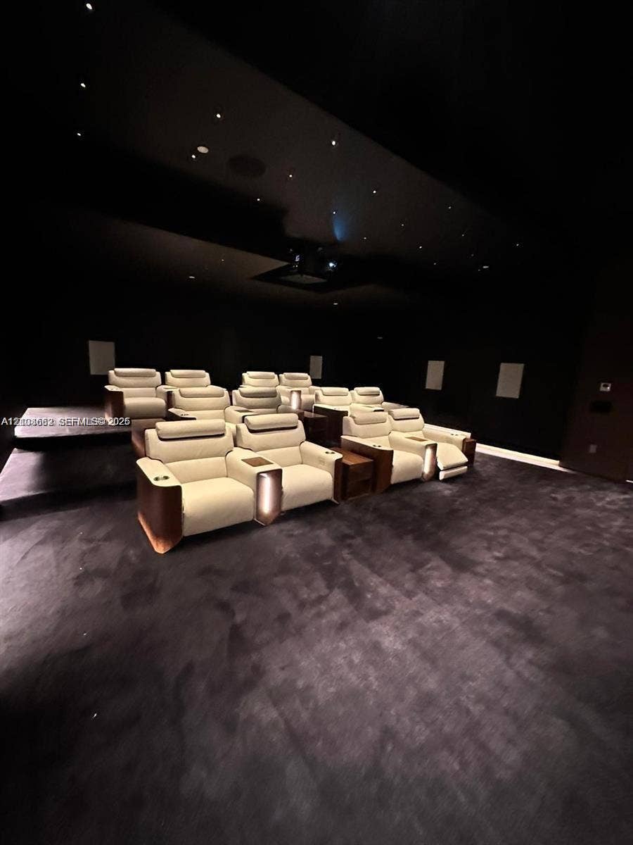 300 Biscayne Boulevard, #2709W, Miami, Miami, FL 33131 Dedicated media room featuring tiered flooring, dark wall treatments, ceiling-mounted projection equipment, and recessed fiber-optic star lighting