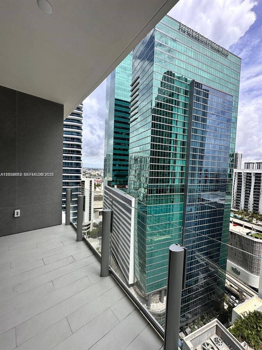 300 Biscayne Boulevard, #2709W, Miami, Miami, FL 33131 Covered balcony featuring grey tile flooring, recessed ceiling lighting, and a glass panel railing